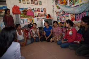 Phong, in blue, talks with other garment workers about their rights. 