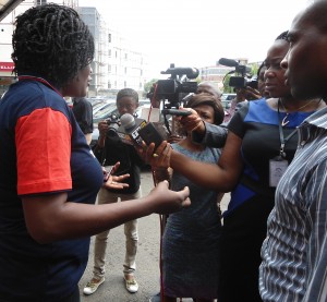 Abuja, Nigeria: Reporters interview Ngozika Reginald during a Bring Back Our Girls rally. Photo courtesy of Womankind Centre for Women Empowerment.