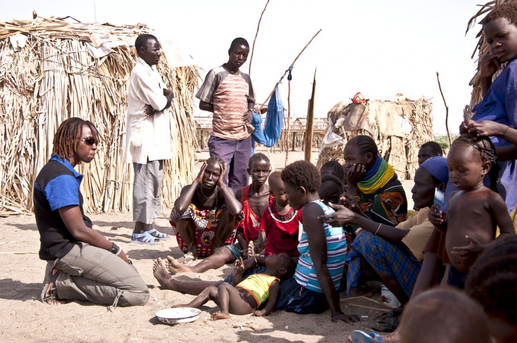 Activist Ikal Angelei (left) of AJWS grantee Friends of Lake Turkana  speaks to local villagers about their struggle against the Gibe III dam. 