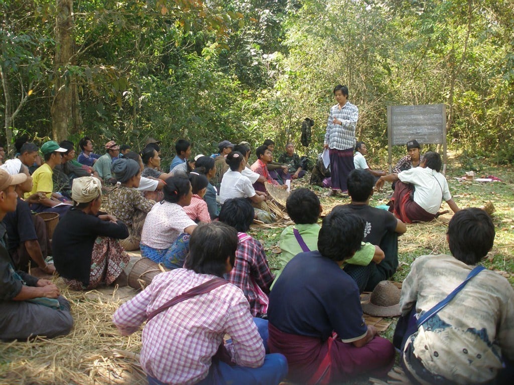 A KESAN staff member talks with farmers about their land rights. Photograph courtesy of KESAN. 