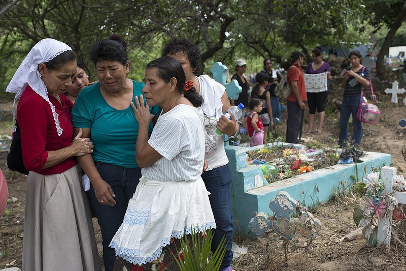 The mother of an assassinated bus driver buries her son at a cemetery on the outskirts of San Salvador. By Encarni Pindado for NPR