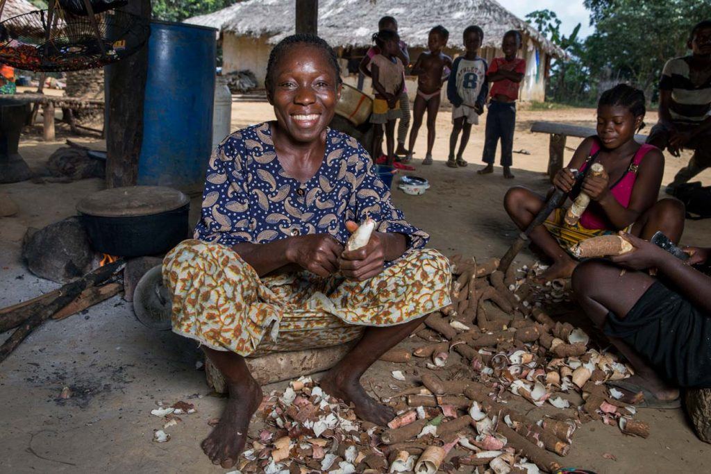 Blayah Town women’s leader Teresa Davis peels cassava, a starchy root vegetable that is grown locally and is central to the diet of most Liberians.