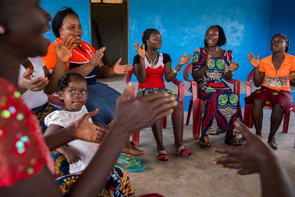 BAWODA members sing and clap during a meeting in Fortsville, Grand Bassa County.