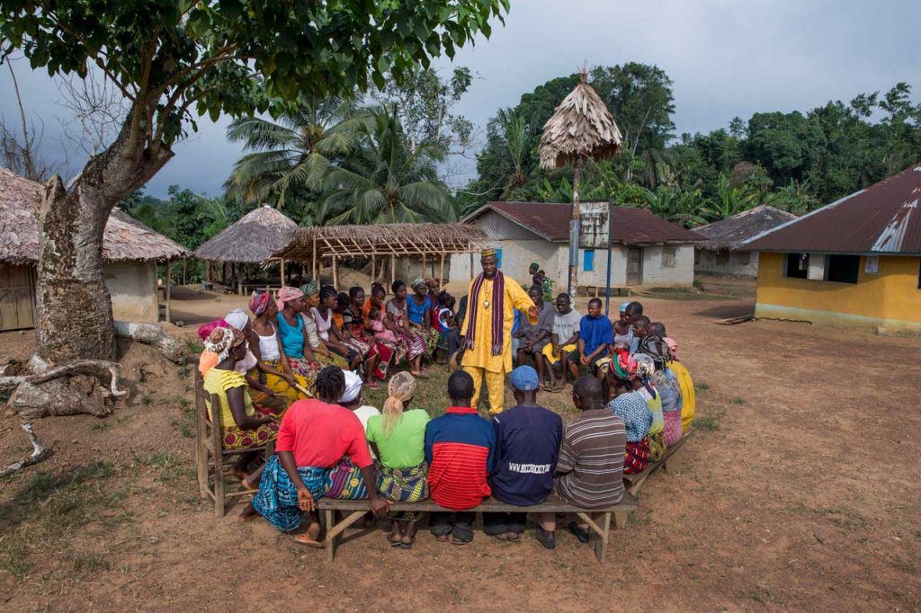 A chief elder (center, in yellow) leading a community meeting in Grand Bassa County, Liberia, in January 2016. The new bill aims to give local communities greater say over how their land is used. Photo by Jonathan Torgovnik