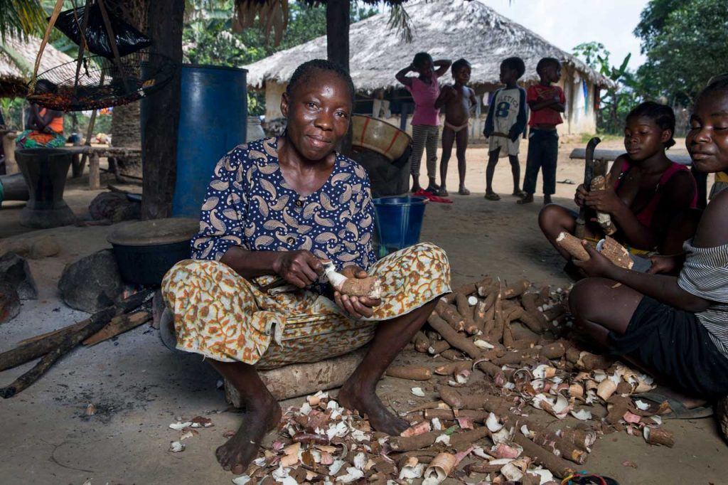 Blayah Town women’s leader Teresa Davis 45, peels locally grown cassava. Like many, Teresa depends on community land for food to sustain her family. Photo by Jonathan Torgovnik