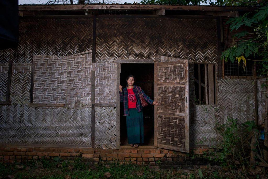 Ja Hkawn at the site of her old home and store, which she was forced to abandon and is now in ruins.