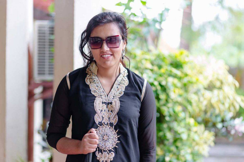 Despite her visual impairment, Sarita Lamichhane is ensuring women with disabilities are not forgotten in Nepal’s recovery efforts. In this photo, she faces the camera smiling, wearing sunglasses and carrying her white cane. Photo by Ben Beringuela 