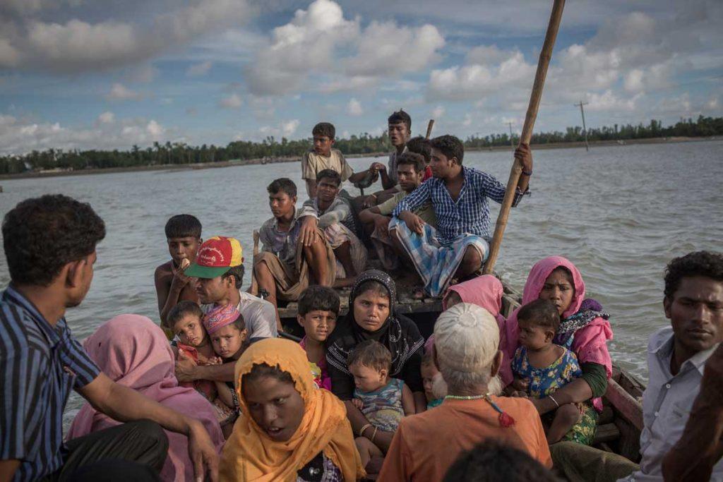 Rohingya men, women and children fleeing for safety on a crowded boat. AP Images