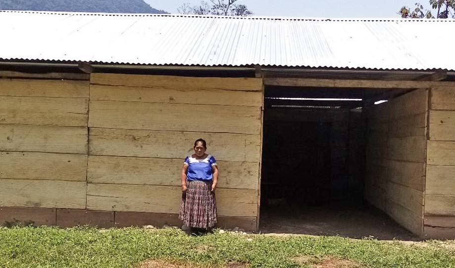 Rufino Chén Quip in front of her rebuilt residence. Photo courtesy PDP.