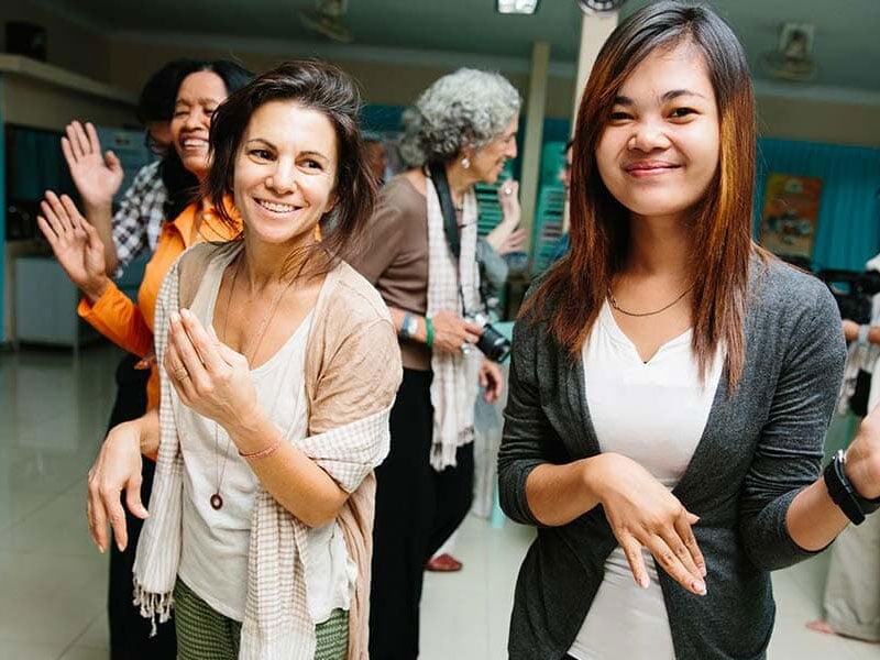 photo of women smiling and dancing