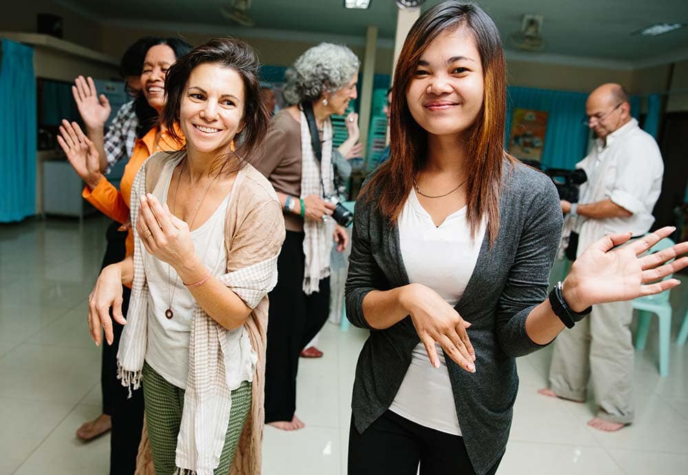 photo of women smiling and dancing