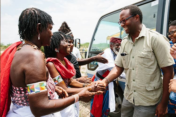 group of women shaking a man's hand