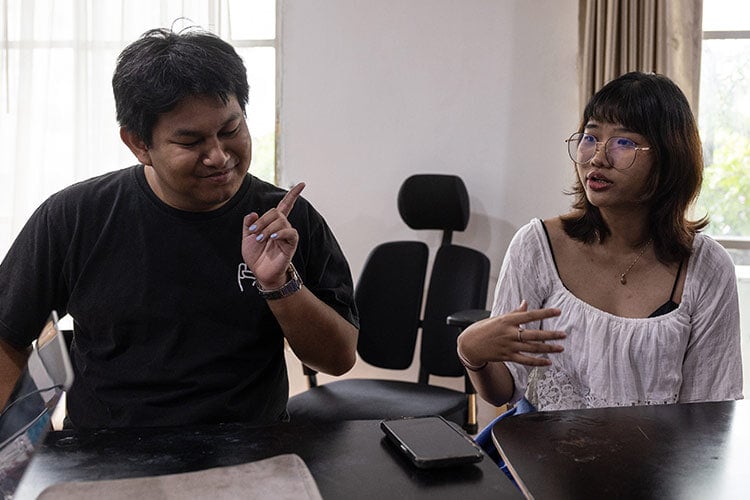 two people working together at a desk