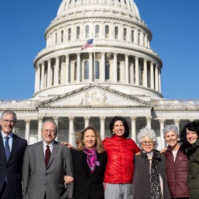 group of people standing in front of the capitol