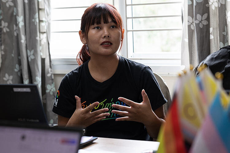 person speaking animatedly at a desk