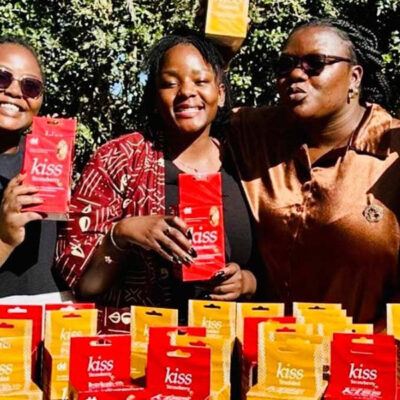 three women outdoors smiling at the camera