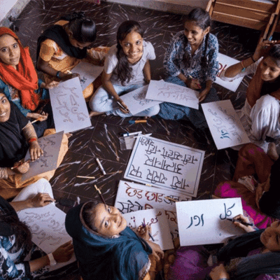 group of girls sitting in a circle looking up