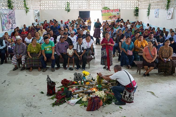 large group of people sitting and watching a ceremony