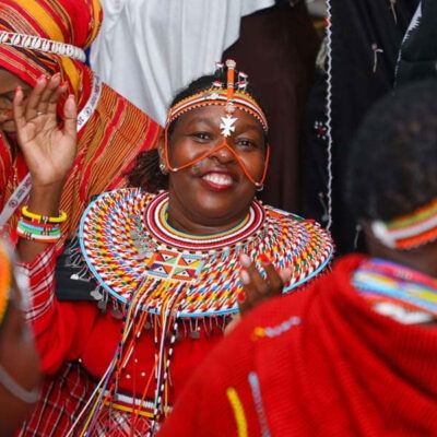 woman in indigenous outfit and smiling and dancing