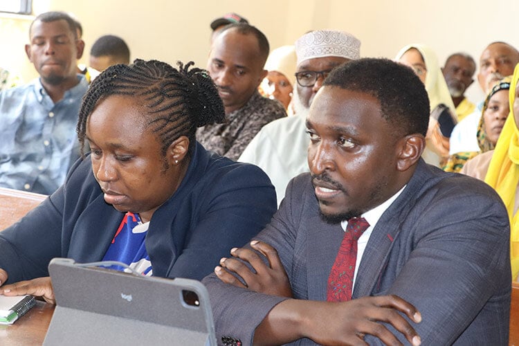 close up of two people in suits at court
