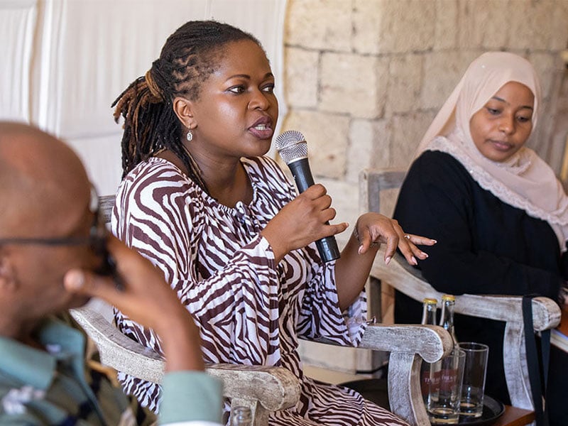 a woman speaking into a microphone