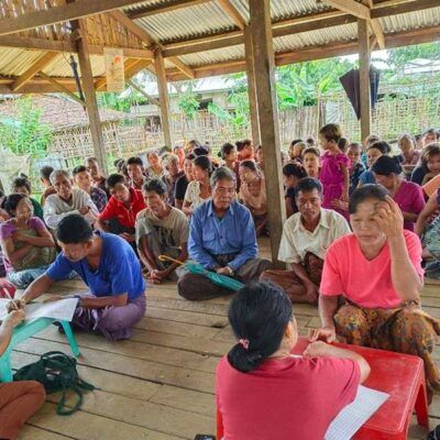 many people seated on the floor for a workshop