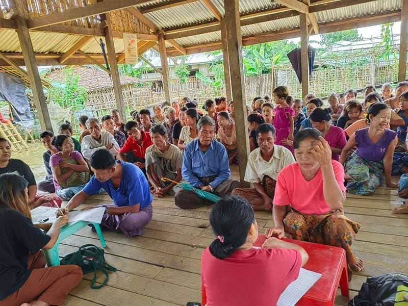 many people seated on the floor for a workshop