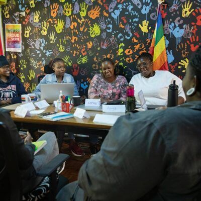 six people sitting around a table together