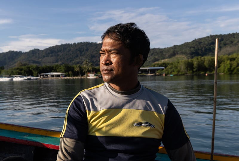 man on a fishing boat on the water