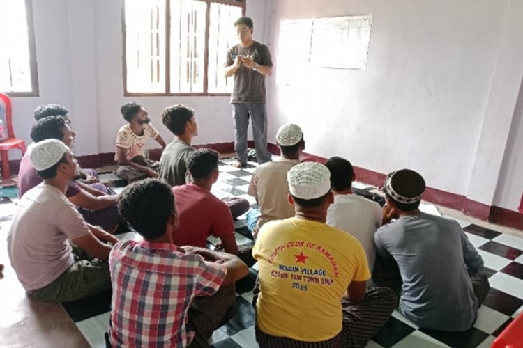 PDI staff member standing in front of group of seated people conducting a workshop