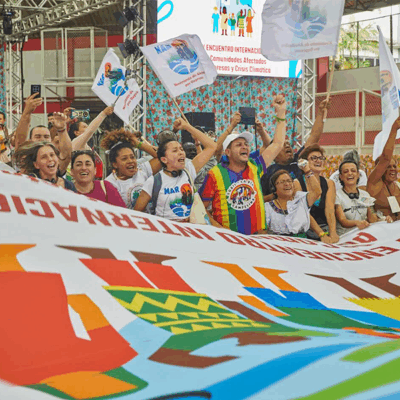 large group of people behind a banner