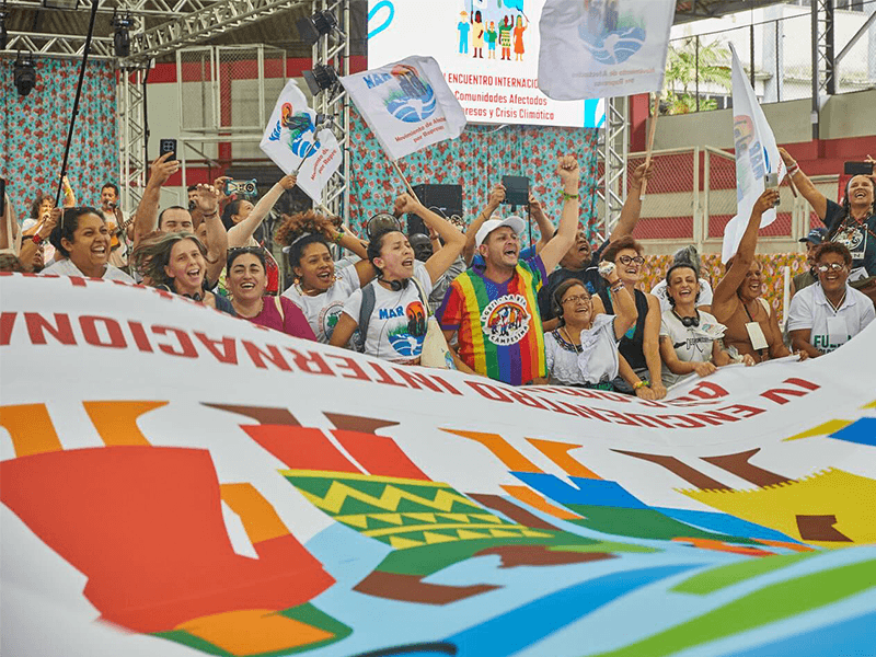 large group of people behind a banner