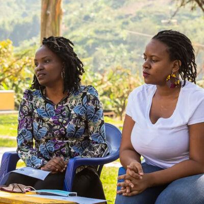 two women sitting and listening to someone