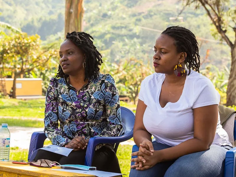 two women sitting and listening to someone