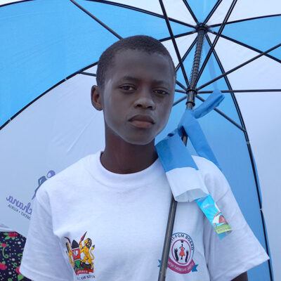young girl looking at camera, holding an umbrella