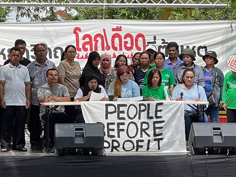 group of people behind a banner