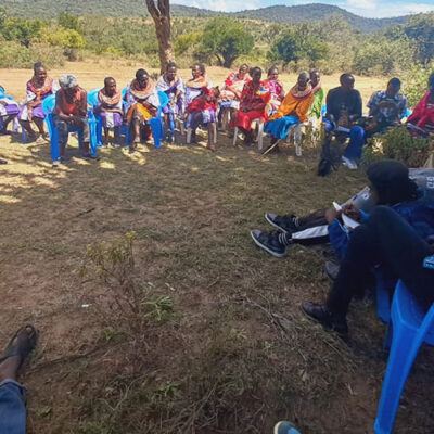 group of people sitting on ground in a circle