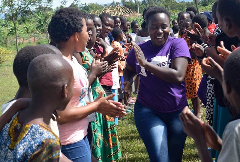 large group of young women outside and smiling