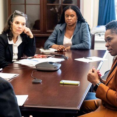 five people seated and speaking around a conference table on Capitol Hill