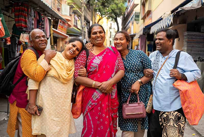 group of five people smiling at camera